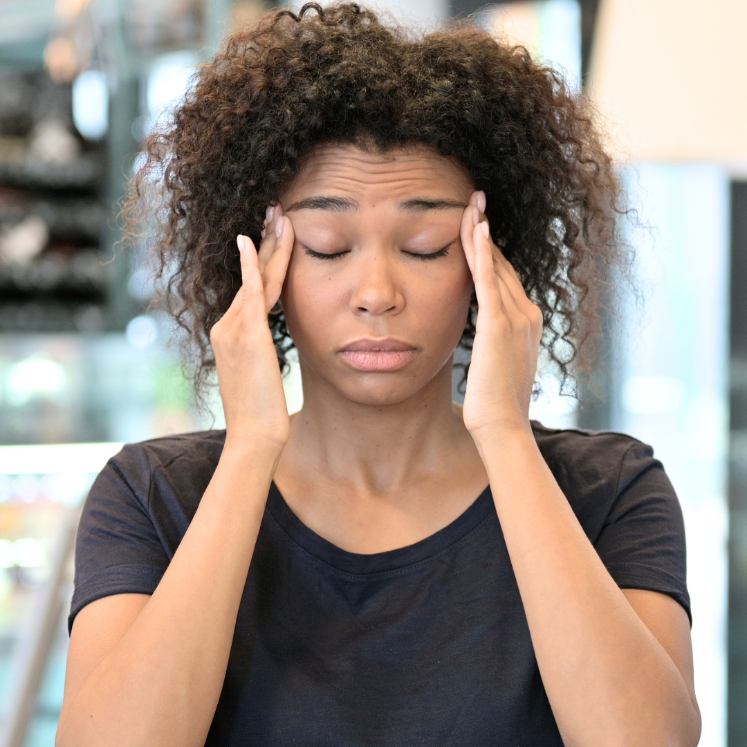 woman rubbing temples frustrated over weight loss
